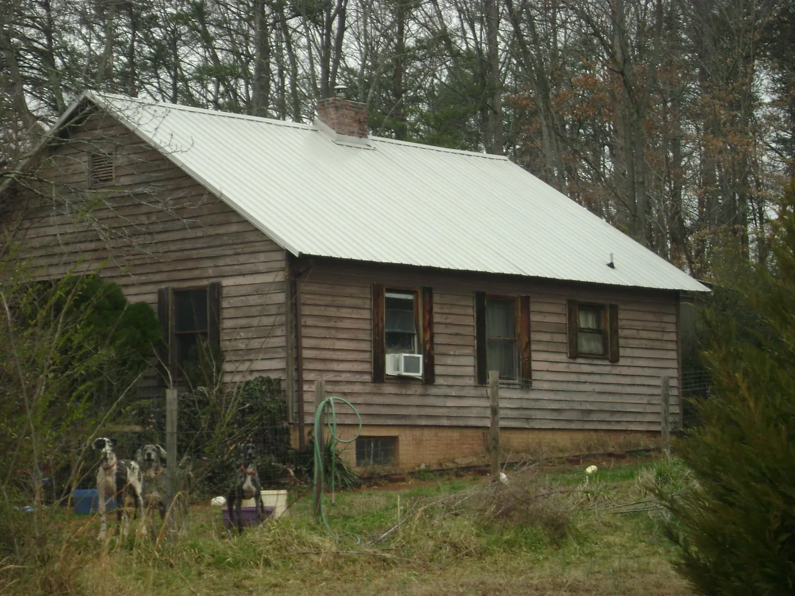 White metal roof on an old wood sided farmhouse, from a Metal Roof Installation job in Manorville